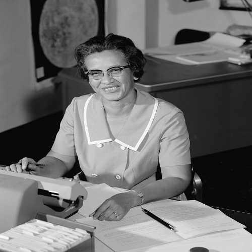 a picture of katherine sitting on a desk with a typewriter